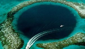 A boat is traveling through a blue hole in the ocean, while charter flights in Florida are available for those looking to explore the Bahamas.