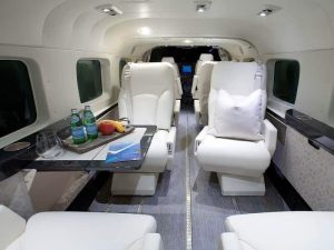 Step inside a private jet, featuring luxurious white leather seats. Whether you're looking for charter flights in Florida or planning to charter a plane to the Bahamas, this upscale interior will provide unparalleled comfort