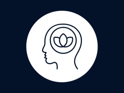 Silhouette of head with lotus flower inside on dark background.